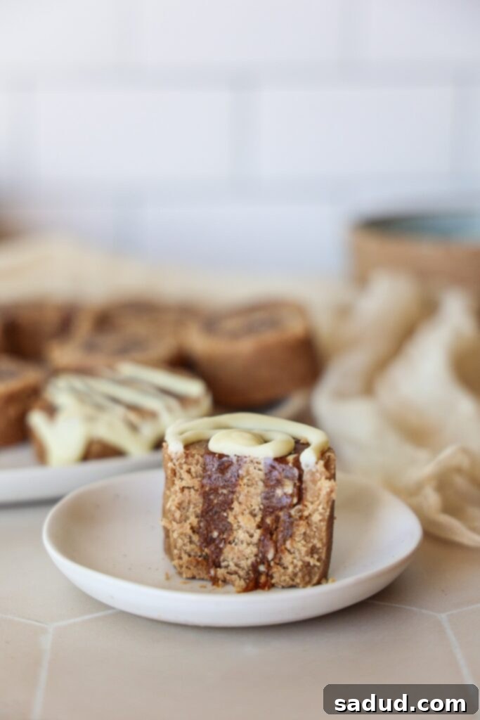 All the wholesome ingredients for raw vegan cinnamon rolls laid out on a table, including oats, dates, and nuts.