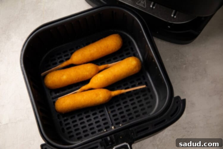Corn dogs in an air fryer basket