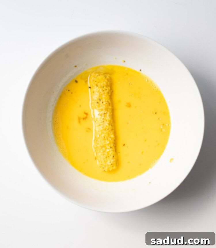 Panko-coated mozzarella stick dipped a second time in egg wash