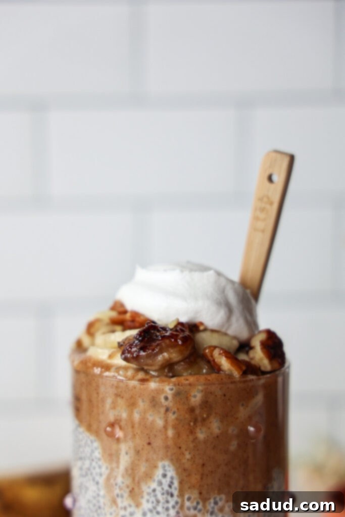 Close-up of Banana Foster Chia Pudding with a dollop of yogurt and rich almond butter caramel.