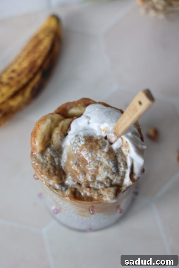 Finished Banana Foster Chia Pudding, topped with pecans and an extra dollop of cream.