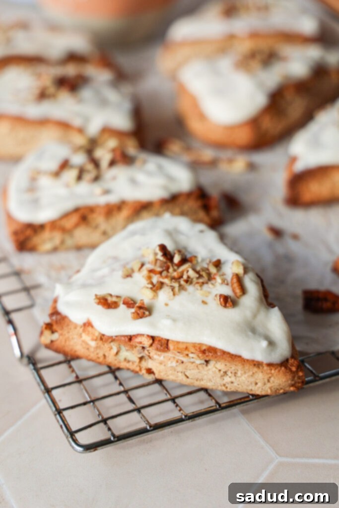 A tray of freshly baked banana nut scones with a drizzle of maple glaze, ready to be served.