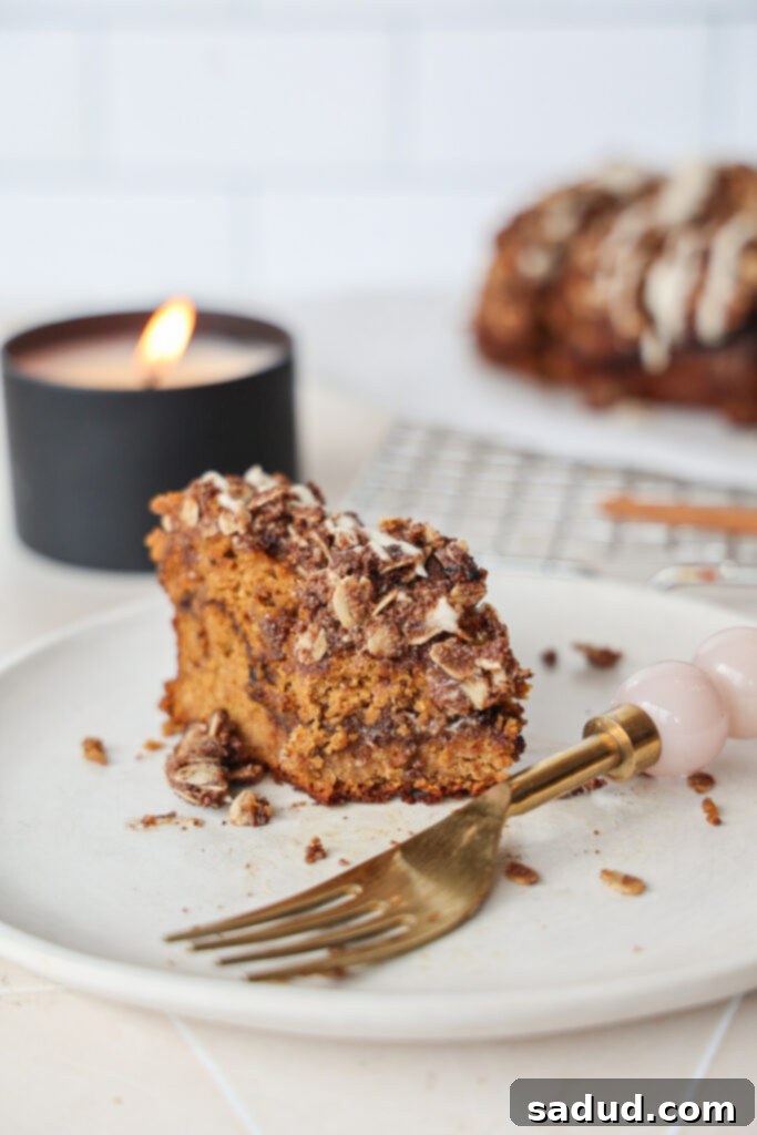 Spiced Gluten Free Dairy Free Pumpkin Streusel Bread 4 A slice of gluten free pumpkin bread with maple glaze and streusel topping.