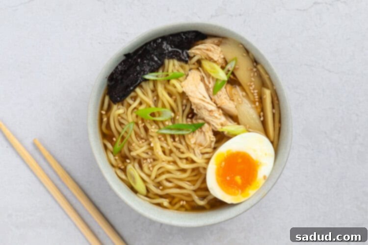 Assembled spicy chicken ramen bowl with toppings