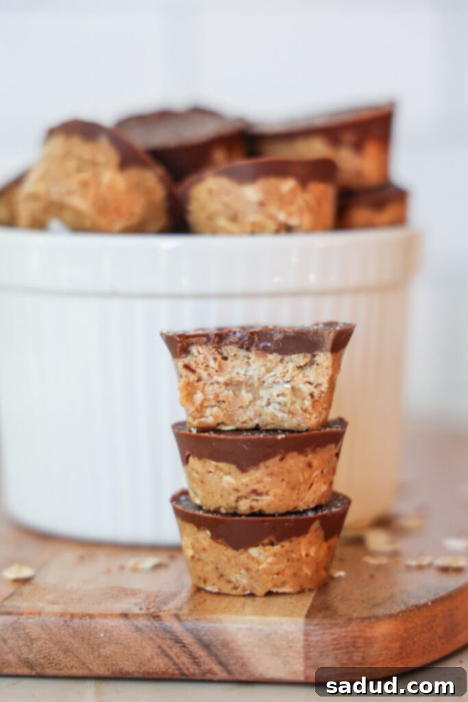 Close-up of freshly made no-bake peanut butter oat cups topped with melted chocolate and a sprinkle of sea salt.