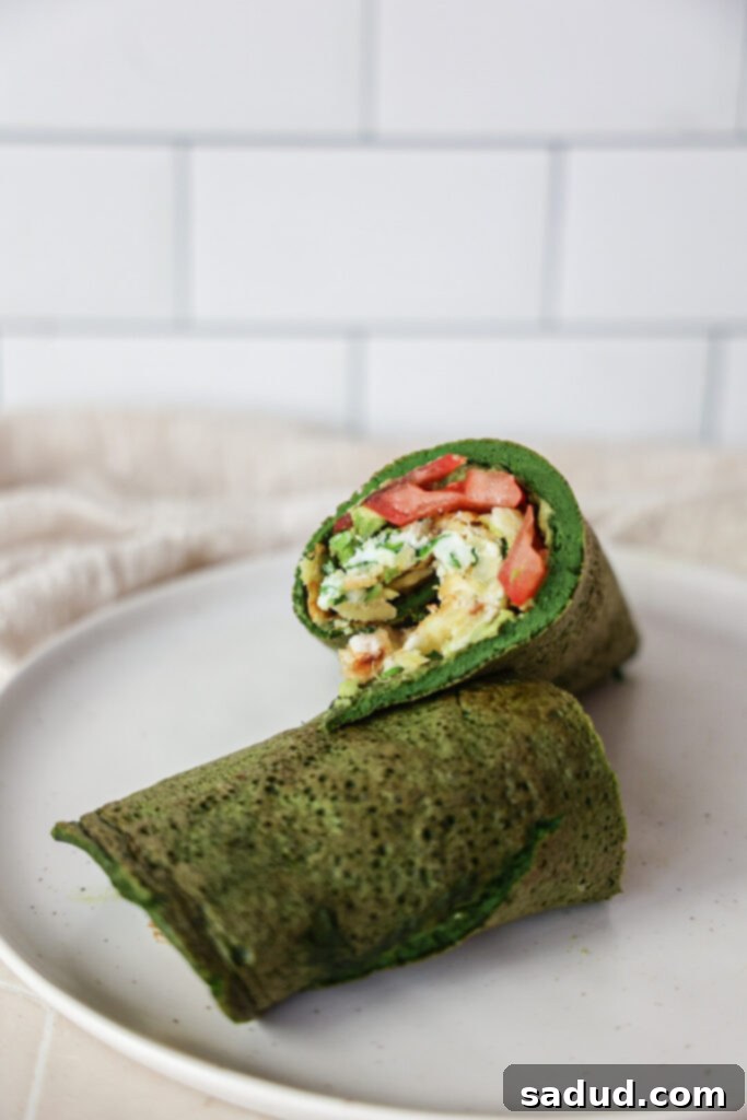 A healthy spinach wrap with eggs and breakfast potatoes, showcasing a vibrant green color.