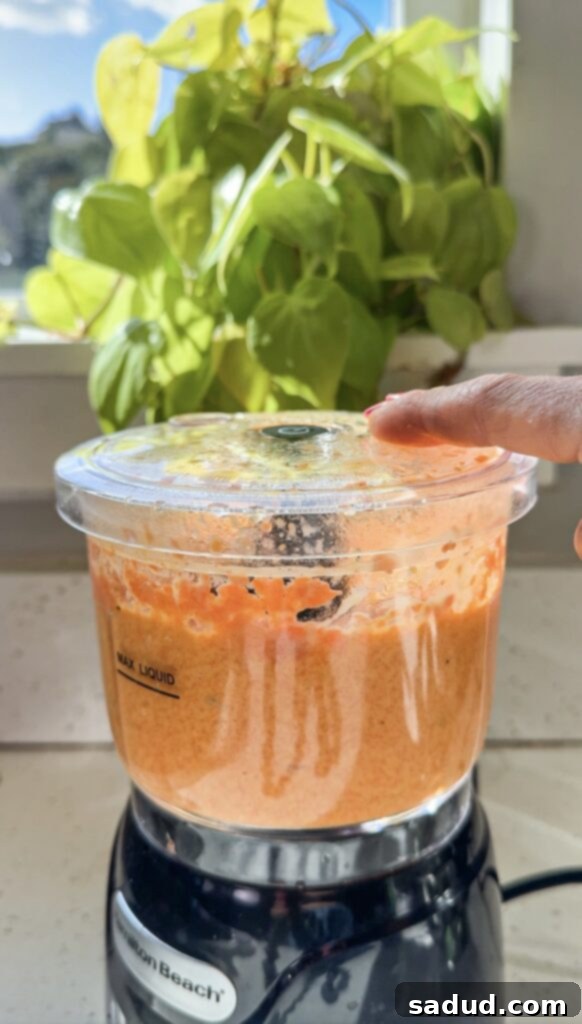 Vibrant Japanese Carrot Ginger Dressing 4 Blender with ingredients for carrot ginger salad dressing.