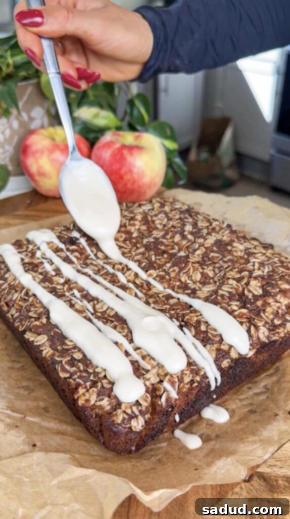 Slice of gluten-free apple cake with vanilla glaze