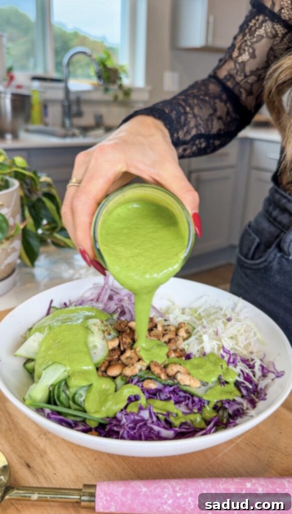 Vibrant Vegan Green Goddess Dressing 5 Green goddess dressing over salad.
