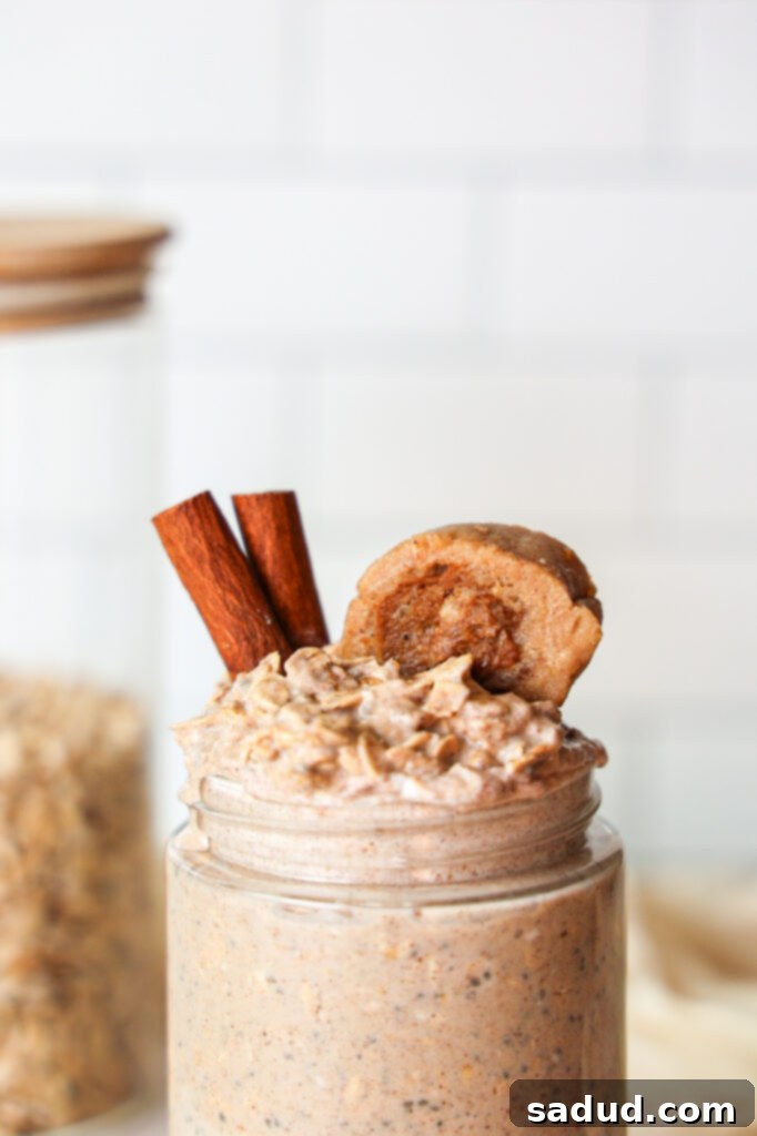 Two jars of cinnamon roll overnight oats, ready for the fridge.