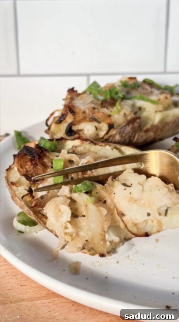 Close-up of a French onion twice baked potato, showing the creamy filling and melted cheese.