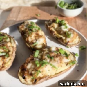 French Onion Twice Baked Potatoes on a plate, garnished.