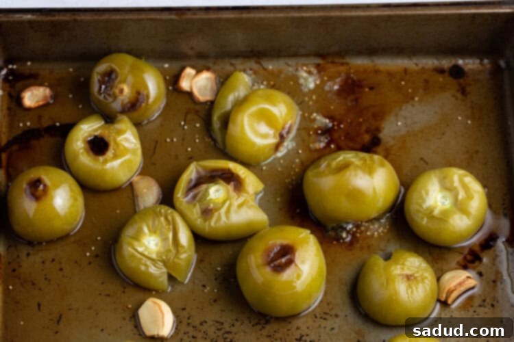 Charred tomatillos on a baking sheet