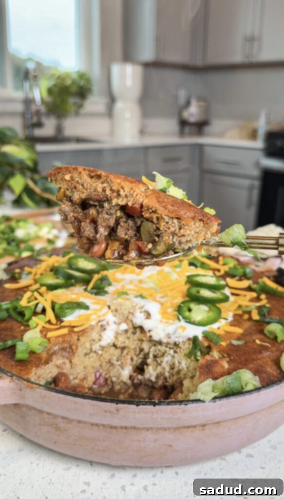Effortless Cornbread Chili Bake 8 A vibrant and healthy serving of gluten-free Cornbread Chili Casserole, topped with fresh avocado and cilantro.