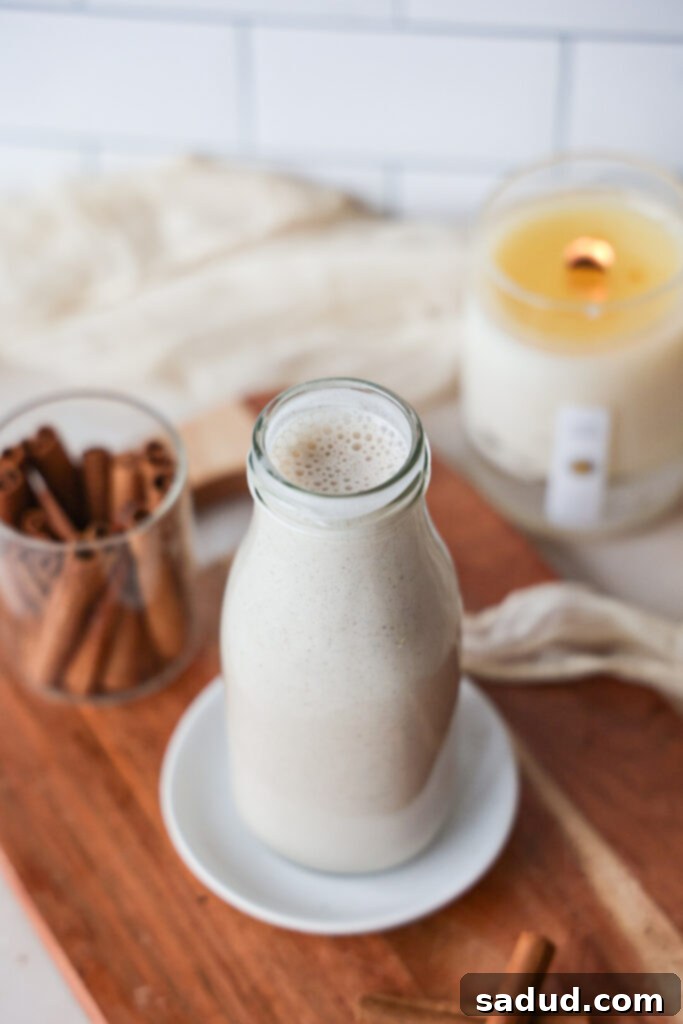 Creamy Vegan Eggnog Perfection 3 Two glasses of homemade eggnog without eggs or dairy, topped with fresh nutmeg.