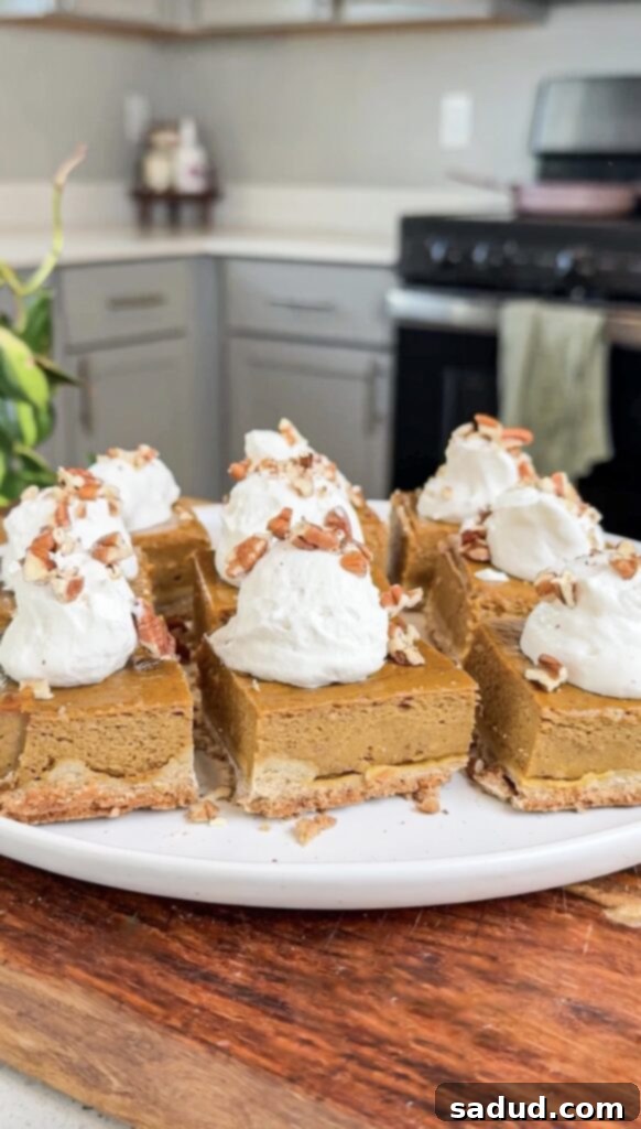A gluten-free, paleo pumpkin pie bar with whipped cream and pecans.