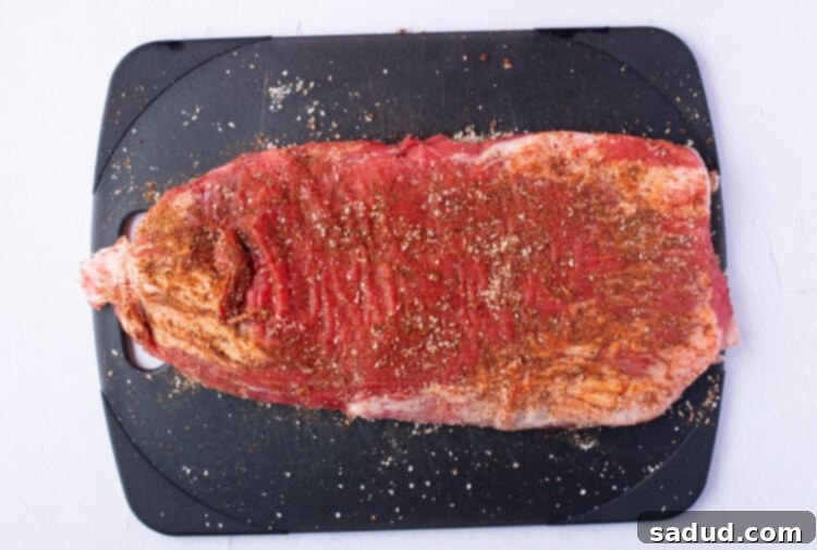 Seasoned flank steak on a cutting board