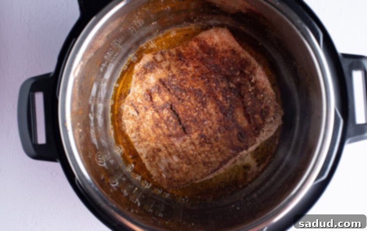 Seasoned flank steak in olive oil in the Instant Pot